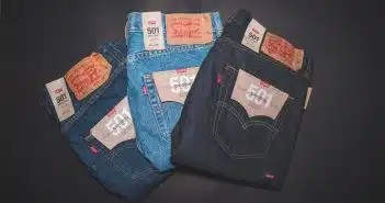 blue denim jeans on black textile