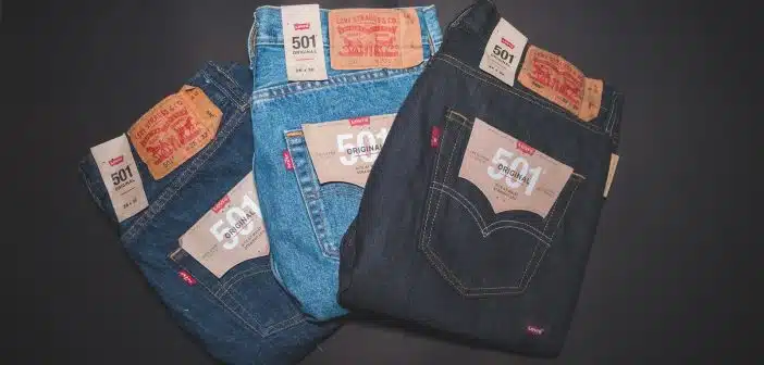 blue denim jeans on black textile